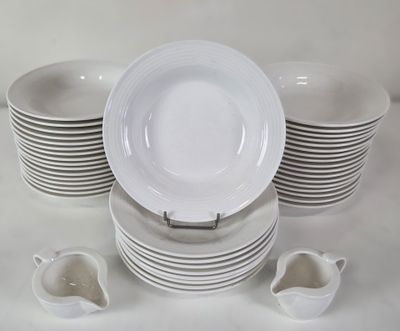 a lot of white plates and cups on the table