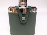 a green leather flask with a silver lid