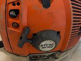 an orange and black blower sitting on top of a wooden table