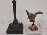 a statue of an eagle and a clock on a marble table