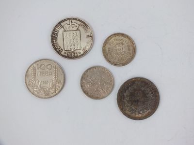 four different types of coins sitting on top of a white surface