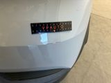 a sticker on the hood of a white car