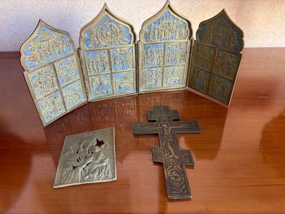 four crosses and a plaque on a table