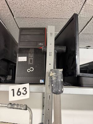 une photo d'un ordinateur posé sur une étagère dans un magasin