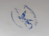 a blue and white plate with a bird on it