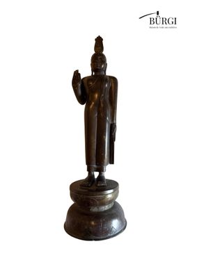 bronze statue of a standing buddha on a pedestal with a white background