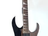 a black electric guitar sitting on a stand on a white surface