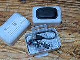 a box with a remote control and a charger on a wooden table