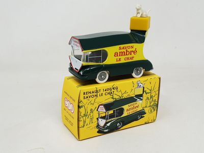 a green and yellow toy truck sitting on top of a box