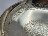 a silver plate that is sitting on a table