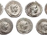 six ancient roman silver coins with heads of men and women