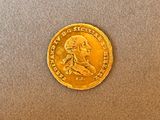 an image of a gold coin with a picture of a man on it