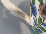 a close up of a coffee cup with flowers on it