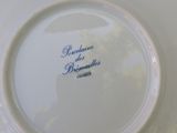a white plate with blue writing on it on a table