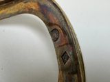 a close up of a metal object on a white surface