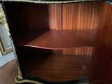 an antique black and gold painted cabinet with drawers and shelves