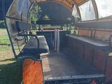 a covered wagon that is parked on the side of the road