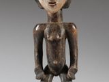 an image of a wooden statue of a man with a crown on his head