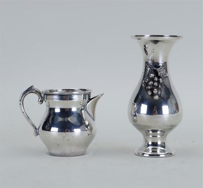 deux vases en argent posés l'un à côté de l'autre sur une table