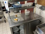 a kitchen with a stove, oven, sink, and other appliances