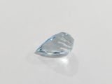 a close up of a blue topaz diamond on a white surface