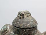 a close up of a statue of a turtle with a lid