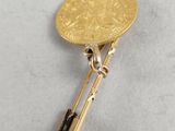 a close up of a gold coin on a metal bar