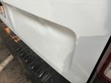 a close up of a white truck parked in a parking lot