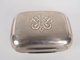 an antique silver cigarette case with a cross on the front
