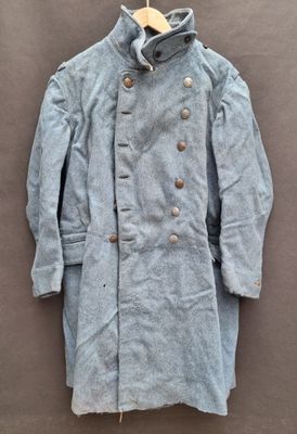 a close up of a coat on a hanger on a wall