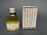 an image of a bottle of perfume sitting next to a box