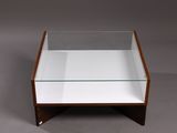 an image of a glass and wood coffee table on a grey background