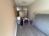 an image of a bedroom with a bed and a desk