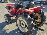 a red tractor that is parked in a parking lot