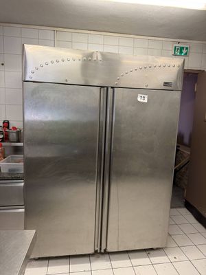 a large stainless steel refrigerator in the middle of a kitchen