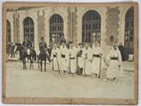 an old photo of a group of people standing in front of a building
