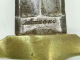 a close up of a knife on a white surface