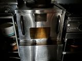 a stove with a pot on top of it in a kitchen