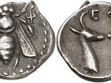 a silver coin with an image of a man and a woman on it