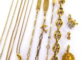 several different types of gold necklaces and bracelets on a white surface