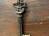 an old key on a wooden table that is missing a keyhole