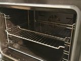an oven with a rack in it that is open