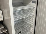 a small refrigerator with a door open in a kitchen