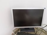 a computer monitor and keyboard sitting on a glass desk