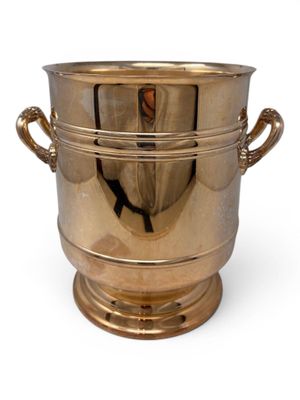a large brass ice bucket with handles on a white background