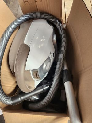 a box with a vacuum and a hose inside of it