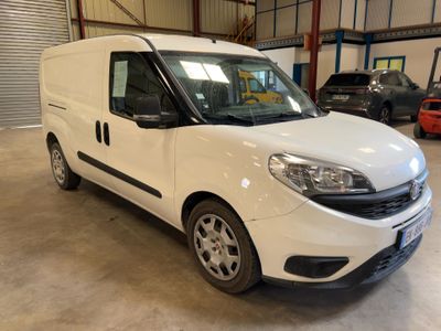 the white van is parked in a garage with other cars in the background