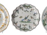 three plates with different designs on them on a white surface