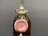 a glass bottle with a wax seal on it