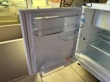 an open refrigerator that is sitting on the floor